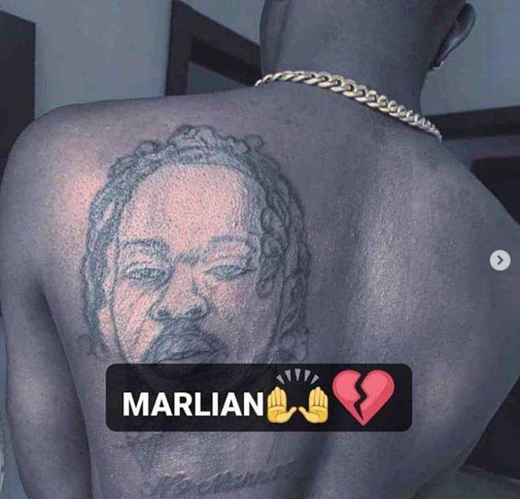 Fan Tattooed Naira Marley's face on his body.